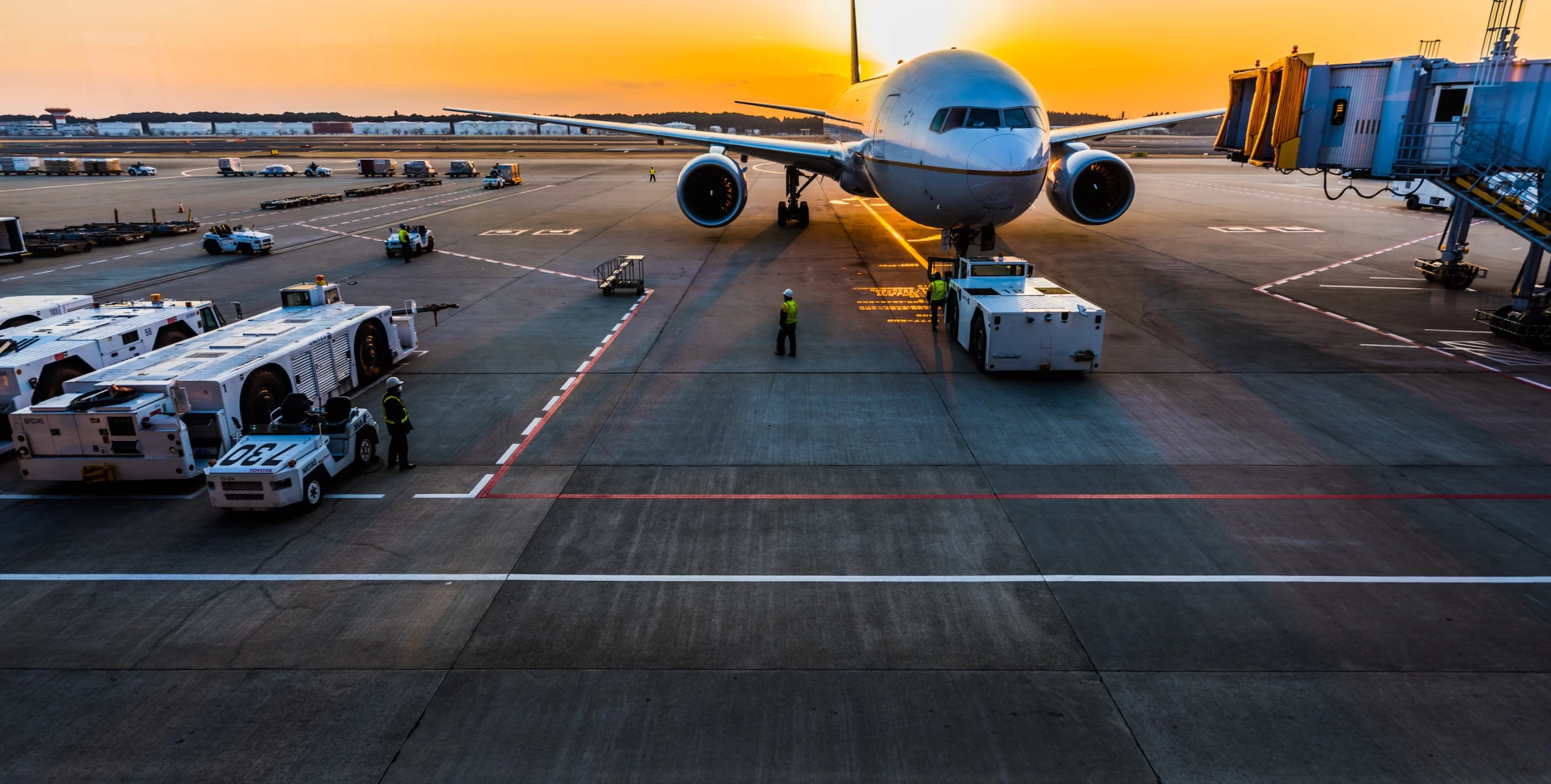 A plane is parked on the tarmac at an airport, potentially carrying air freight.